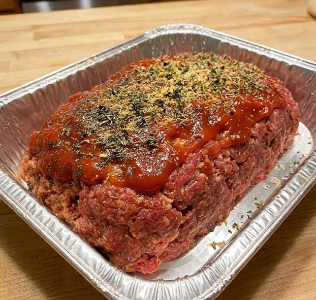 Tender herb-seasoned glazed beef meatloaf fresh from the oven