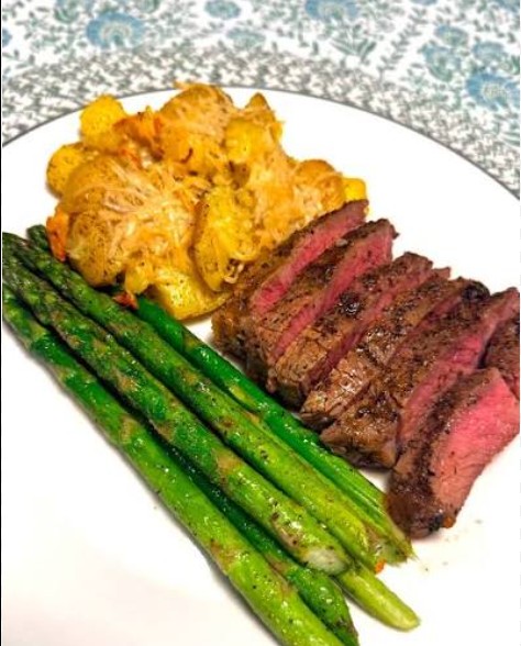 Creamy garlic steak bites served with roasted baby potatoes and asparagus