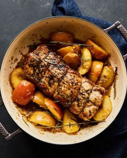 Sliced apple glazed pork roast served with roasted apples and pan sauce